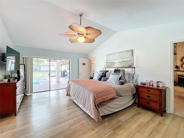 bedroom with ceiling fan, lofted ceiling, light hardwood / wood-style floors, and access to exterior