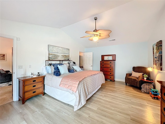 bedroom featuring light hardwood / wood-style floors, vaulted ceiling, and ceiling fan