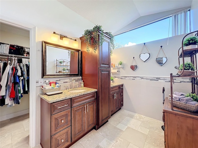 bathroom with vanity and vaulted ceiling