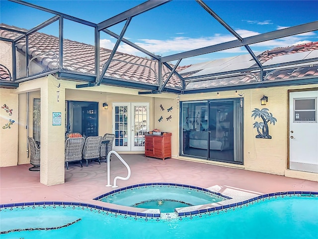 view of pool with french doors, glass enclosure, an in ground hot tub, and a patio area