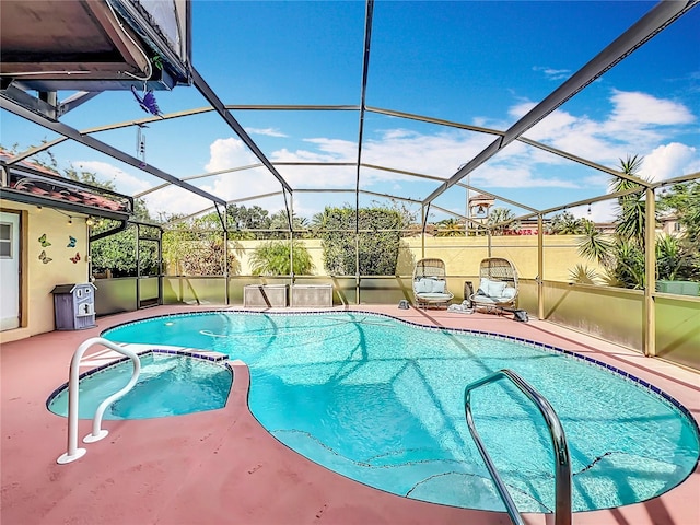 view of pool with glass enclosure