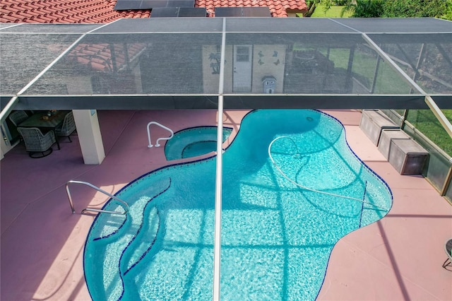 view of pool featuring a patio, a lanai, and an in ground hot tub