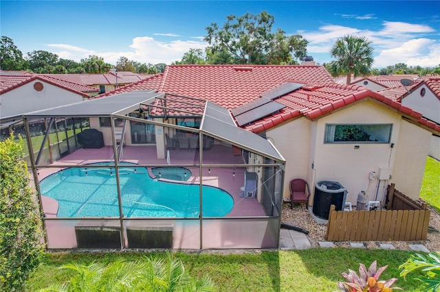 view of swimming pool with glass enclosure and a patio