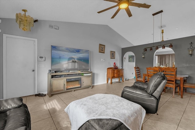 living room featuring lofted ceiling, ceiling fan, and light tile patterned flooring