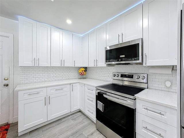 kitchen featuring appliances with stainless steel finishes and white cabinets