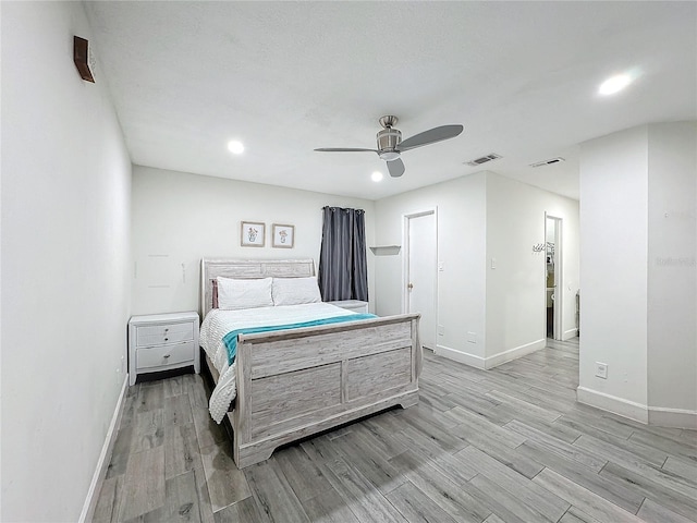 bedroom with light hardwood / wood-style floors and ceiling fan