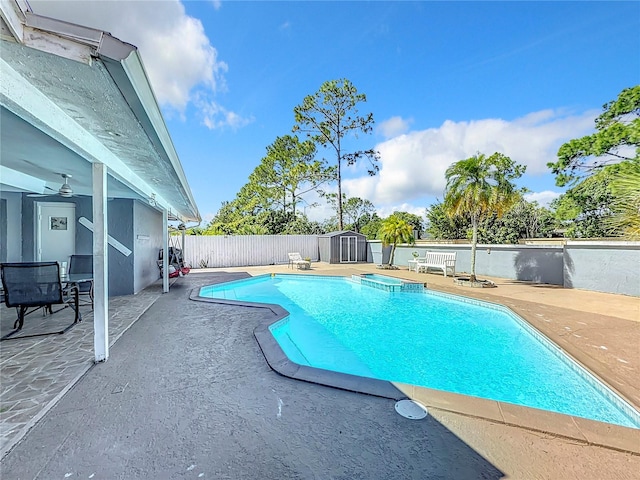 view of pool with a patio and a storage unit