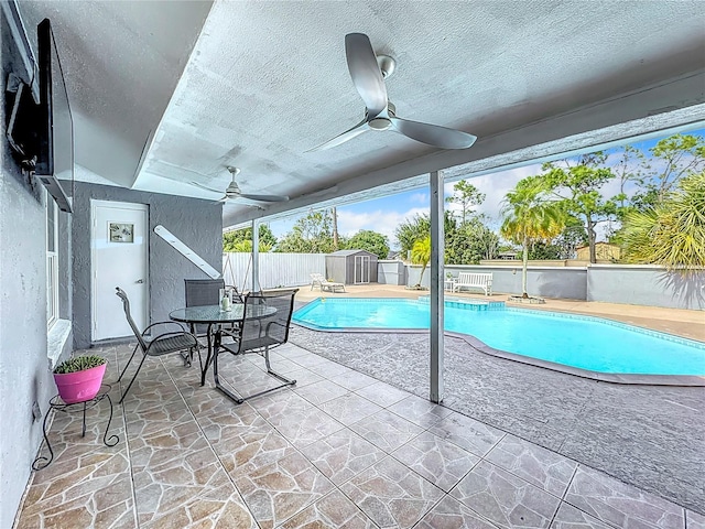 view of pool with a patio and ceiling fan