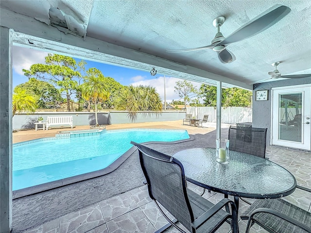 view of swimming pool featuring a patio and ceiling fan