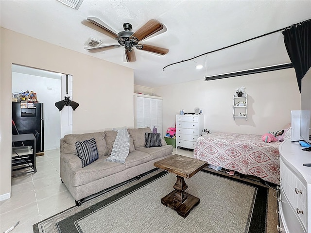 living room with light tile patterned flooring and ceiling fan