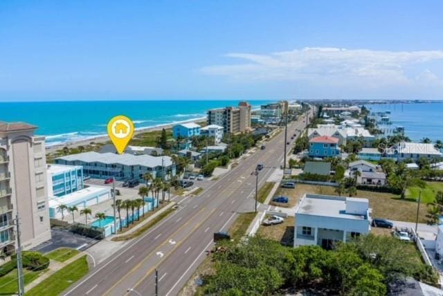 drone / aerial view with a beach view and a water view