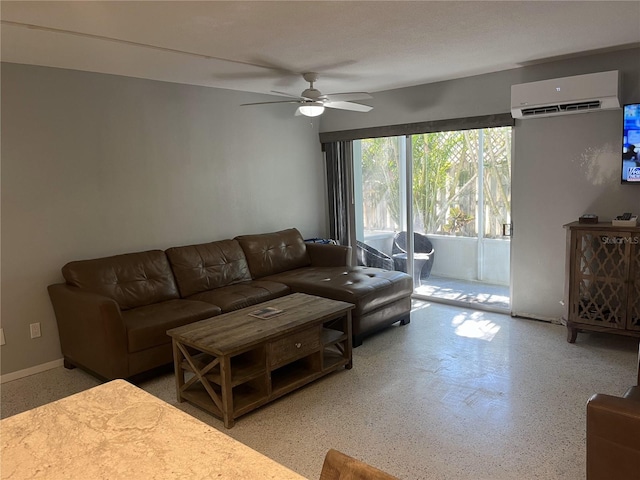 living room featuring an AC wall unit and ceiling fan