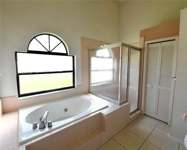 bathroom with tile patterned floors and shower with separate bathtub