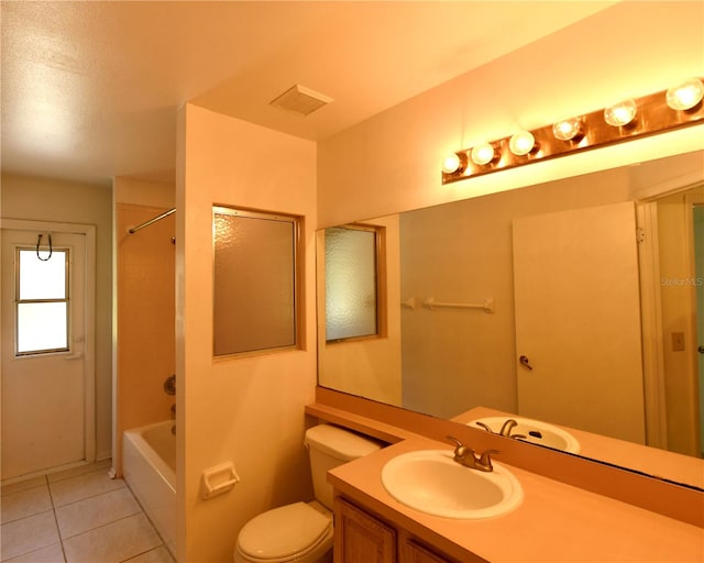 full bathroom featuring vanity, tiled shower / bath, toilet, and tile patterned floors