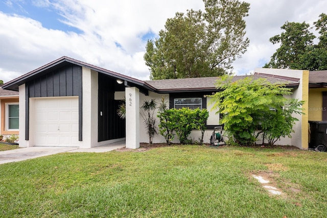 view of front facade with an attached garage, driveway, board and batten siding, and a front yard