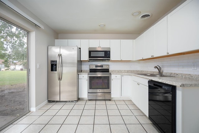 kitchen featuring light tile patterned flooring, stainless steel appliances, white cabinets, and sink