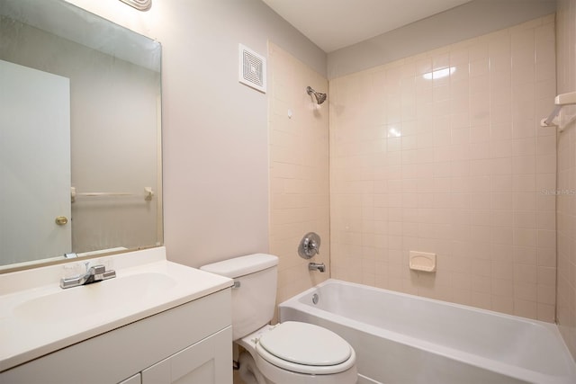 full bathroom with toilet, tiled shower / bath, and vanity