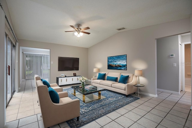 tiled living room with vaulted ceiling, ceiling fan, and a textured ceiling