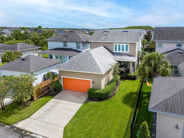 view of front of home featuring a garage and a front lawn