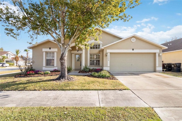 view of front of property with a garage and a front lawn