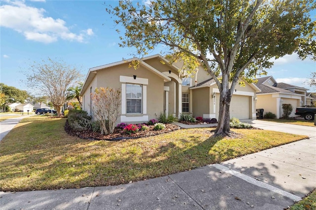 view of front of home with a front lawn and a garage