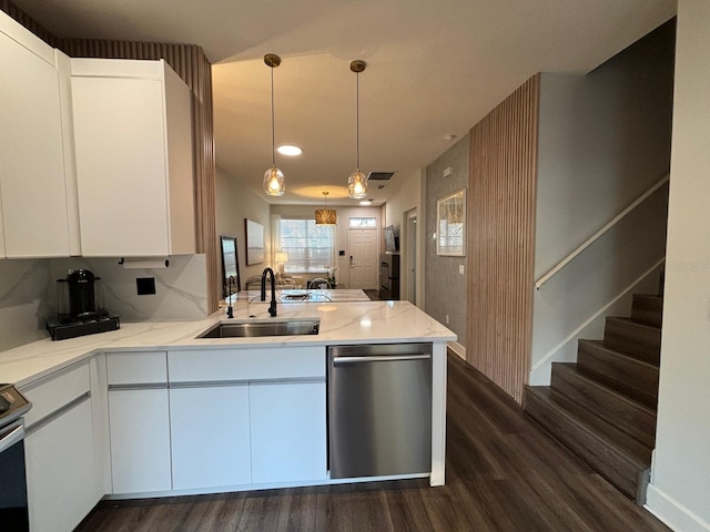 kitchen featuring kitchen peninsula, sink, stainless steel dishwasher, and white cabinets