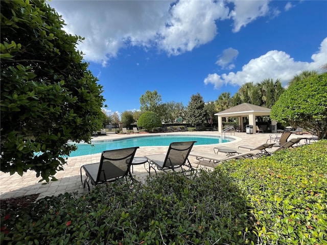 view of swimming pool with a patio and a gazebo