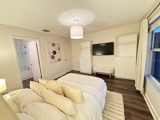 bedroom with a textured ceiling and dark hardwood / wood-style flooring