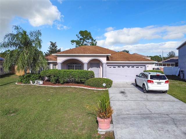 view of front of house with a front lawn and a garage