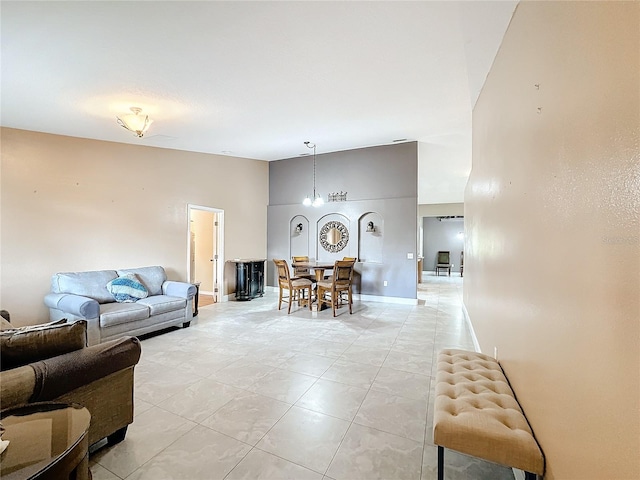 living room featuring a notable chandelier and light tile patterned floors