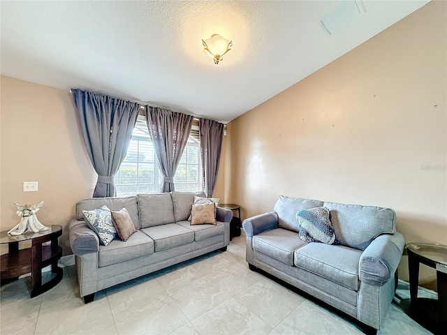 living room with lofted ceiling and a textured ceiling