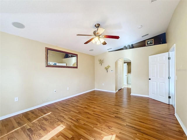 spare room with ceiling fan, vaulted ceiling, and hardwood / wood-style floors