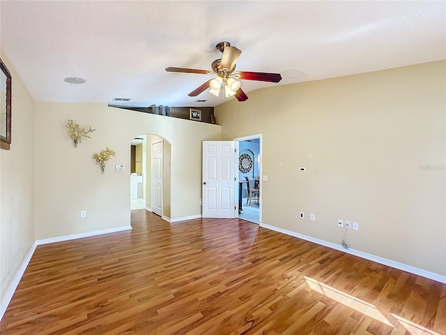 empty room featuring lofted ceiling, a textured ceiling, hardwood / wood-style flooring, and ceiling fan