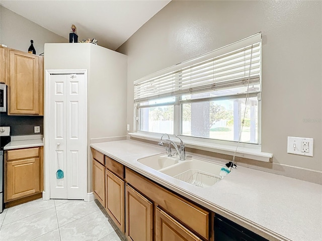 kitchen featuring light tile patterned flooring, appliances with stainless steel finishes, and sink