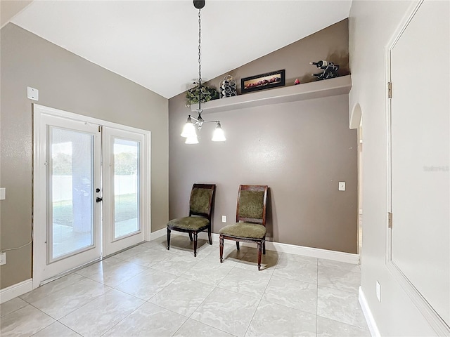 sitting room with lofted ceiling, french doors, and a chandelier