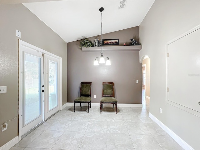 sitting room featuring light tile patterned flooring and vaulted ceiling