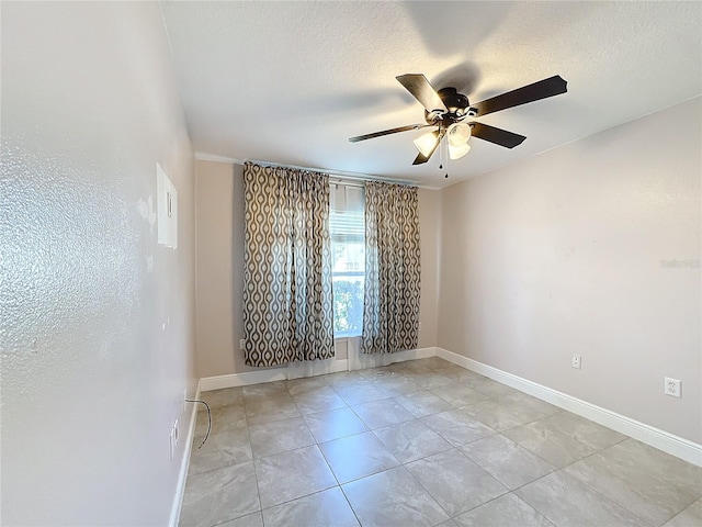 spare room featuring ceiling fan and light tile patterned floors