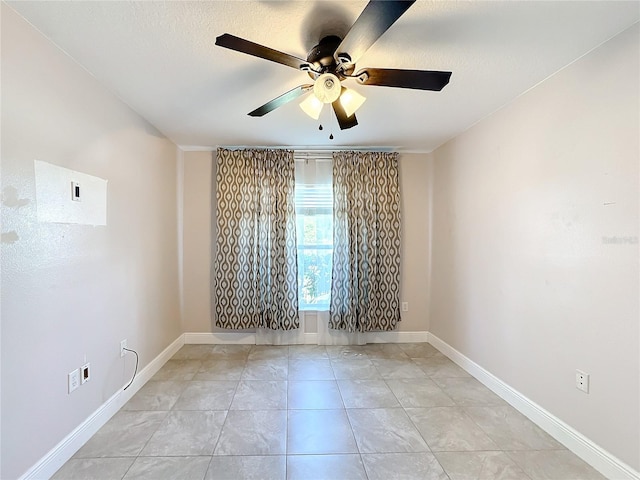 tiled empty room with ceiling fan