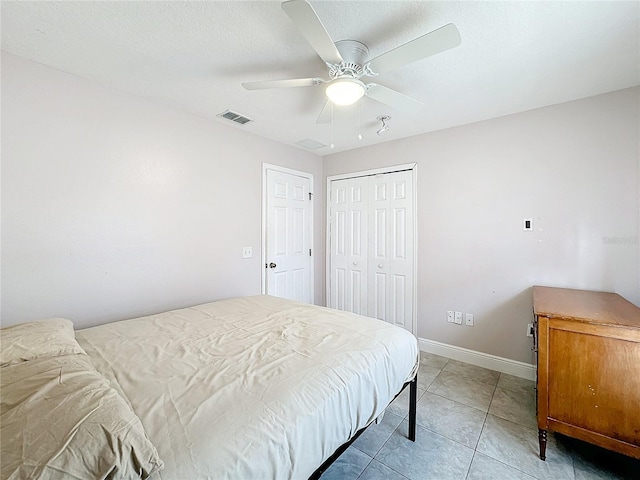 tiled bedroom featuring a closet and ceiling fan