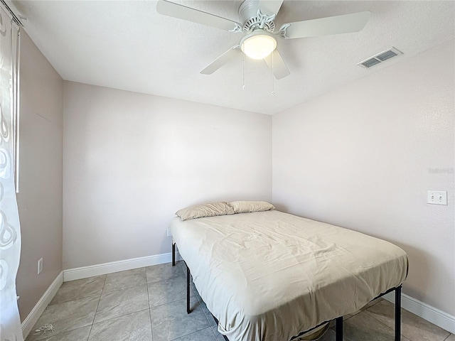 bedroom featuring light tile patterned floors and ceiling fan