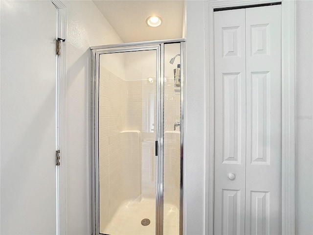 bathroom featuring a shower with door