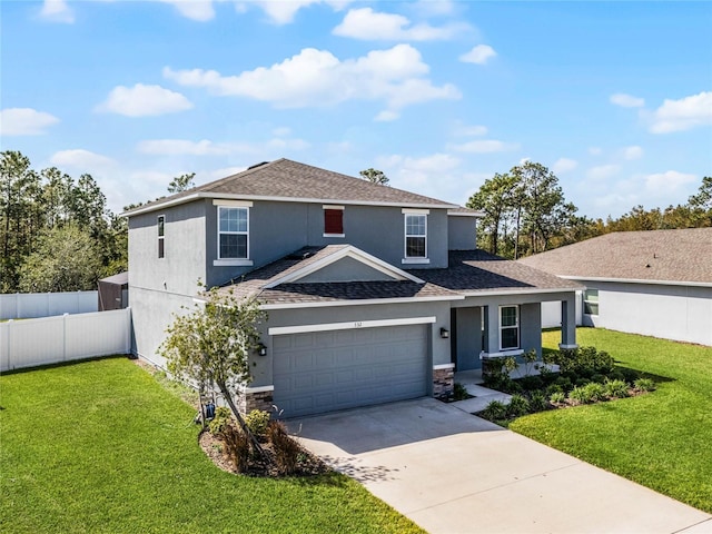 view of front of home with a garage and a front lawn