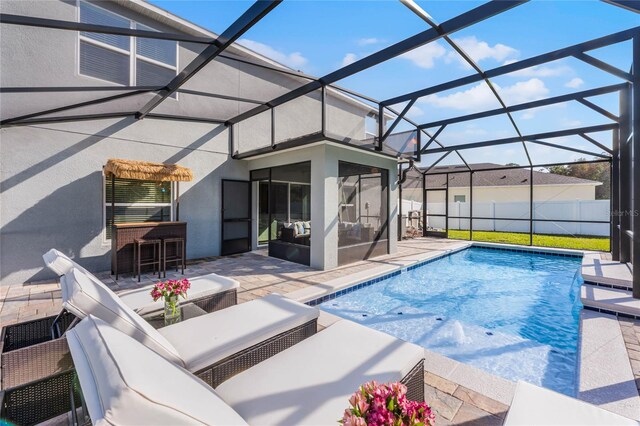 view of pool with a patio and a lanai