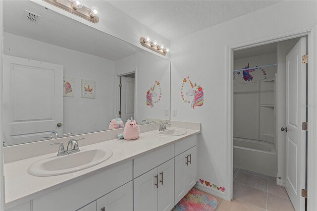 bathroom featuring vanity, a textured ceiling, and tile patterned flooring