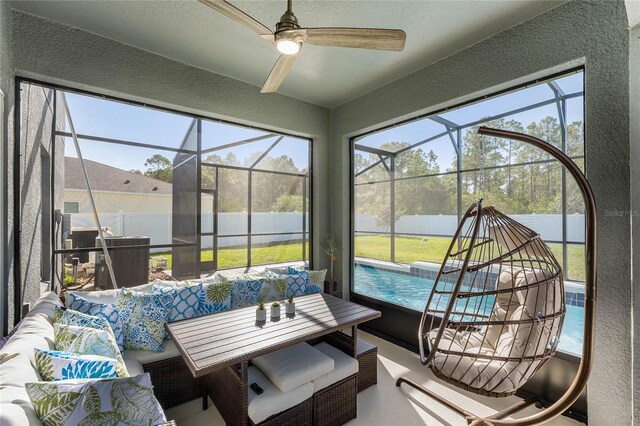 sunroom with ceiling fan