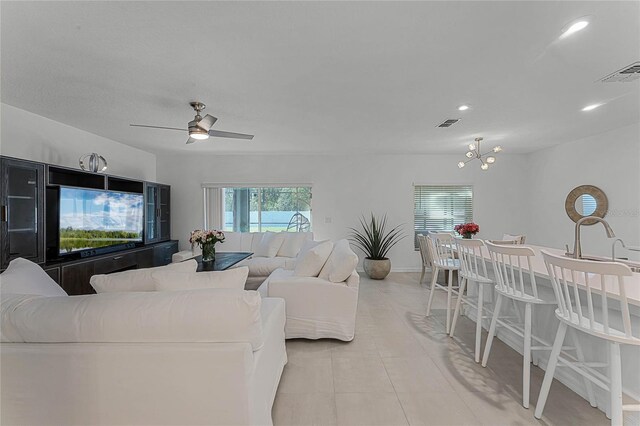 living room featuring light tile patterned floors and ceiling fan