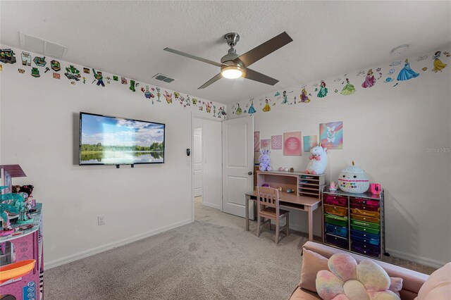 game room featuring ceiling fan, light carpet, and a textured ceiling