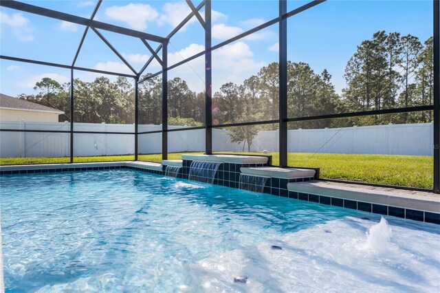 view of swimming pool with a jacuzzi, pool water feature, and a lanai