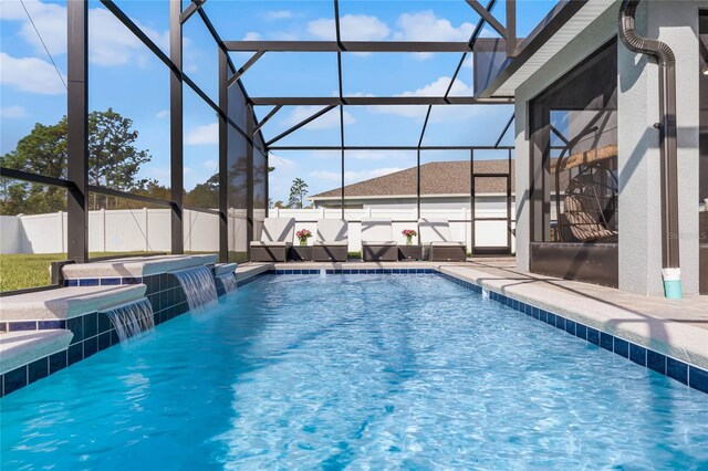 view of swimming pool featuring pool water feature and a lanai