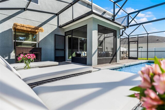 back of property featuring a patio area, a lanai, and a fenced in pool